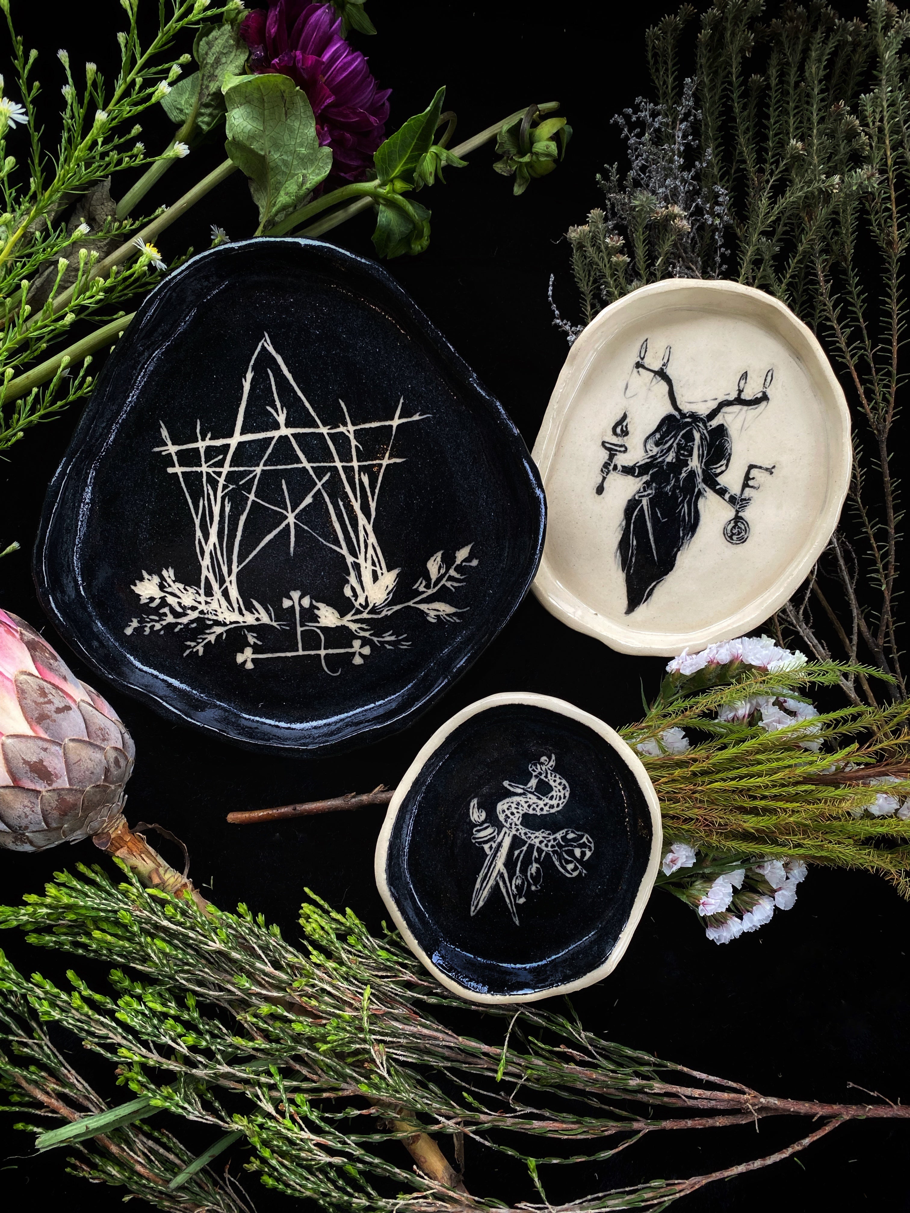 a collection of handmade ceramic plates stoneware by keven craft rituals with snake hecate pentacle the house of twigs