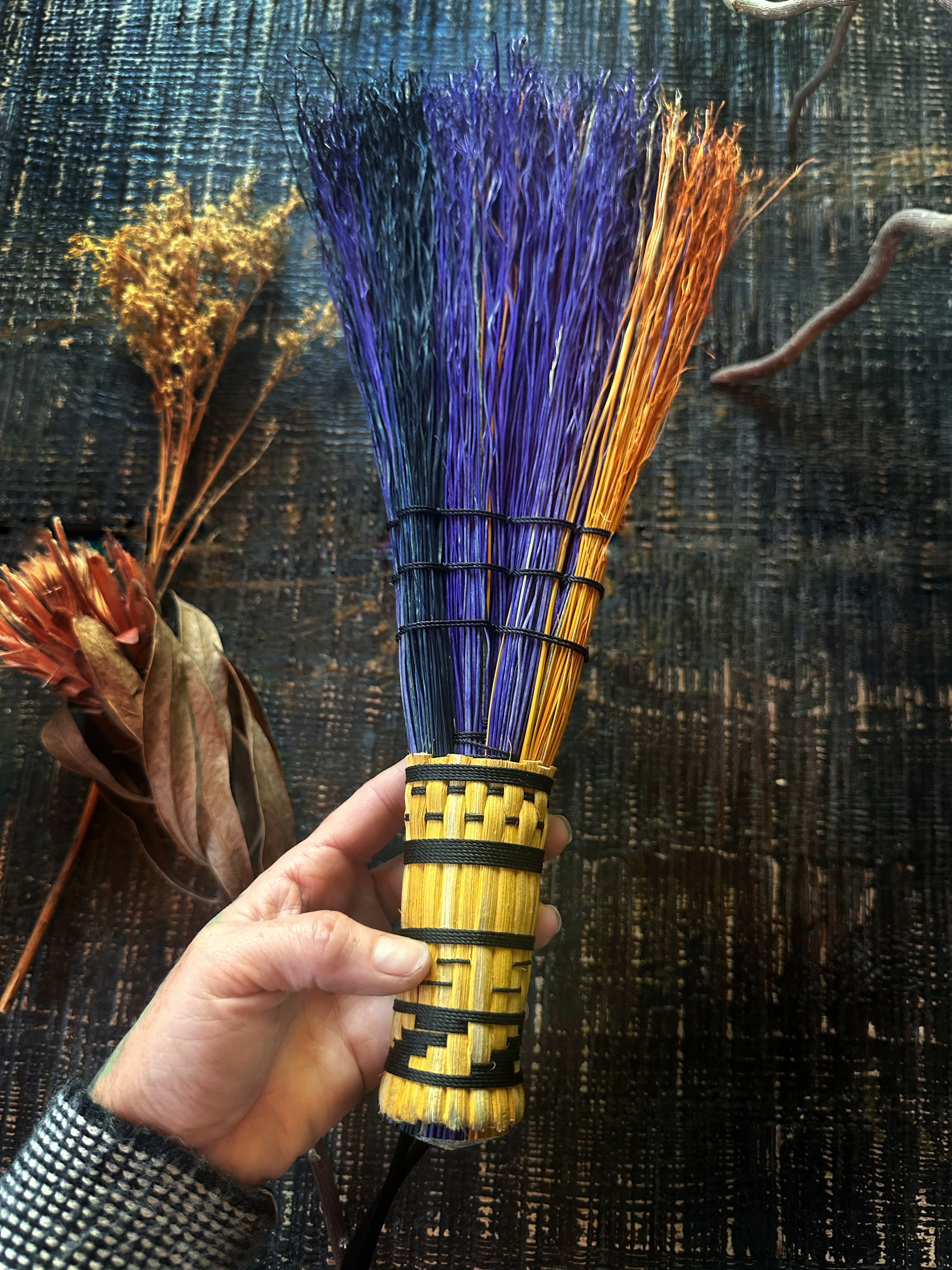 Woven handle stitch broom by seven purple orange and black