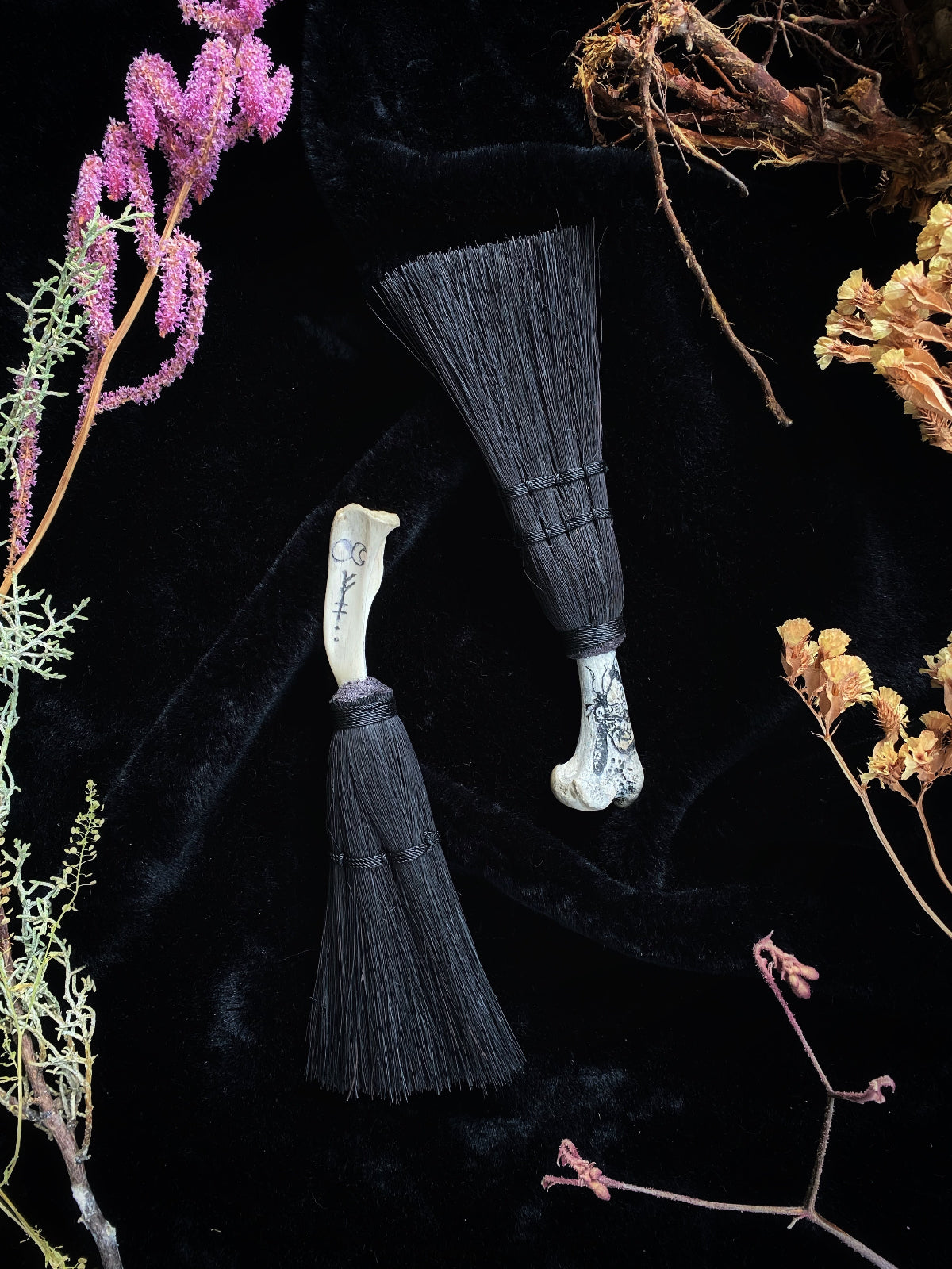 A handmade scrimshaw coyote bone and Tampico fiber broom made by Keven Craft Rituals