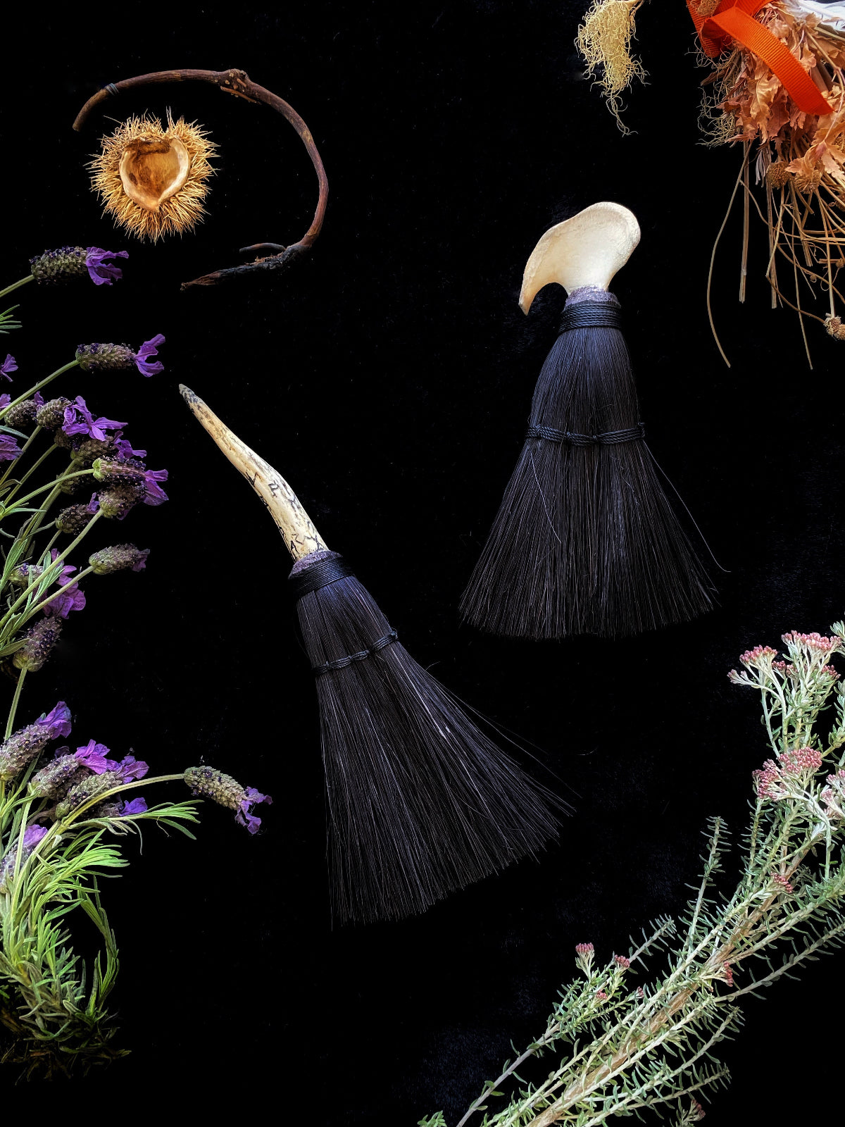 handmade naturally shed deer antler broom with scrimshaw futhark runes carved into them and black Tampico fiber bristles. Handmade by Keven Craft Rituals